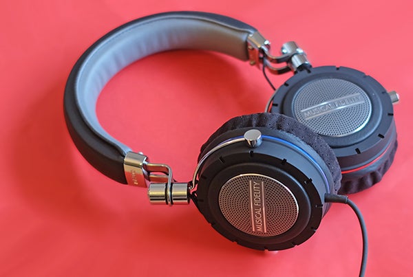 Musical Fidelity MF-200 headphones on red background.