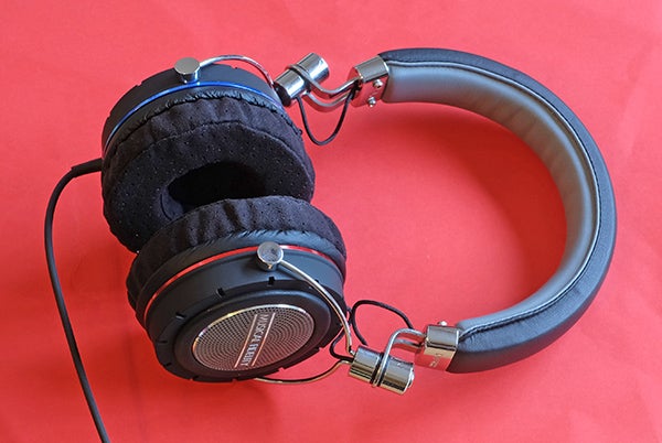 Musical Fidelity MF-200 headphones on a red background.