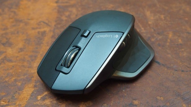 Logitech MX Master wireless mouse on a wooden surface.