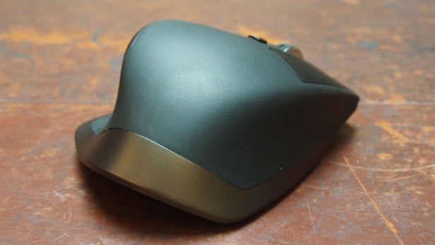 Logitech MX Master mouse on a wooden surface.