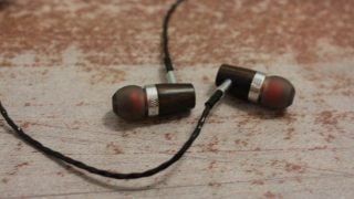Rock Jaw Alfa Genus earphones on a textured surface.