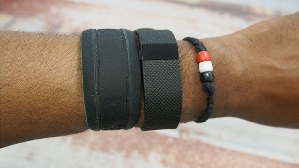 Wrist wearing a Mio Fuse and two other bracelets.