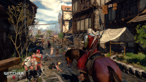 Screenshot from The Witcher 3 showing a bustling medieval town street.