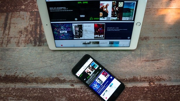 Tablet and smartphone displaying Apple Music app.