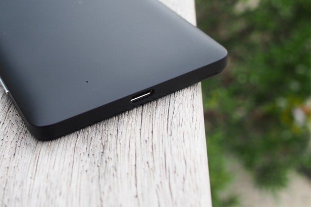 lumia950 35Close-up of a tablet's charging port on a wooden surface.