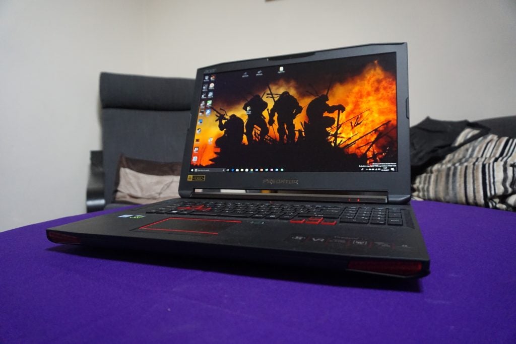 Acer Predator 17 gaming laptop on purple surface with screen on.