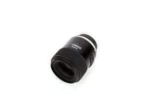 A black Tamron camera lens kept on white background