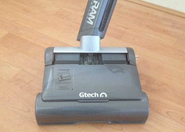 Gtech AirRam cordless vacuum cleaner on a wooden floor.