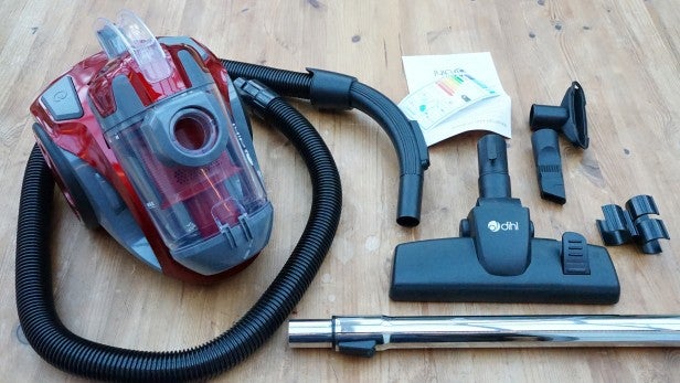 Dihl1400W 1Dihl 1400W Cylinder vacuum cleaner with accessories on floor.