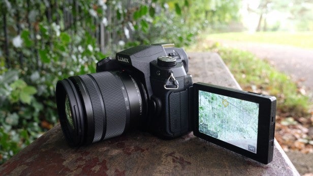 Panasonic G80Digital camera on rock with flipped out screen displaying map.