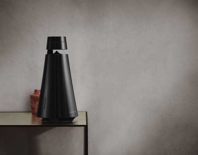 Bang & Olufsen BeoSound 1 speaker on a wooden table.