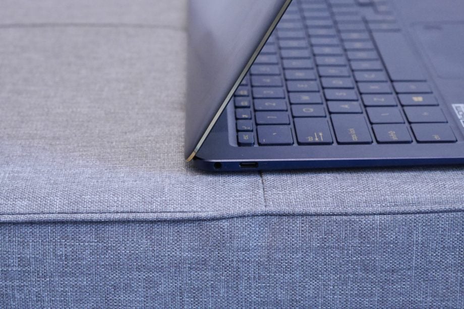 Side view of Asus ZenBook 3 Deluxe UX490UA on fabric surface.