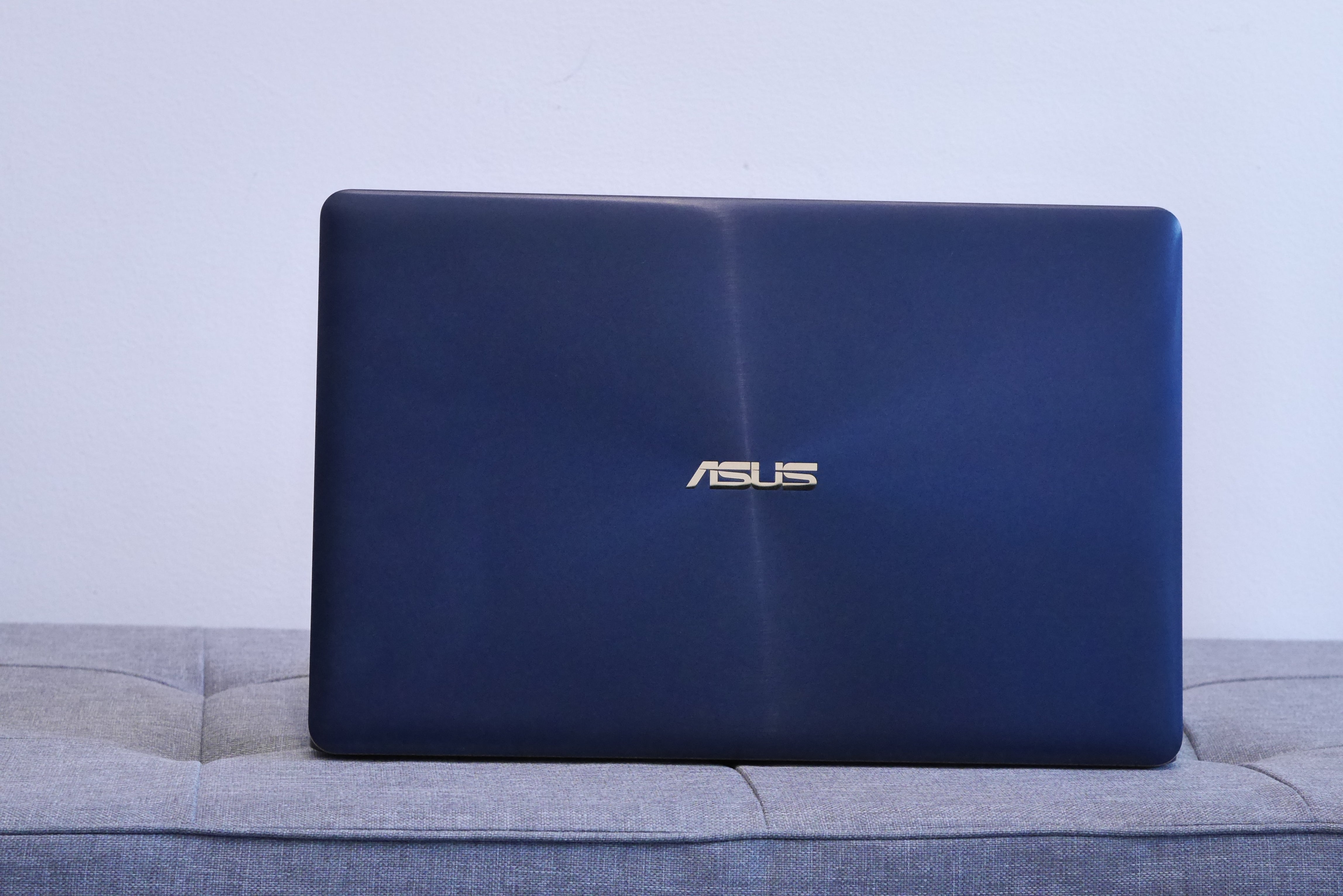 Asus ZenBook 3 Deluxe UX490UA laptop closed on couch.