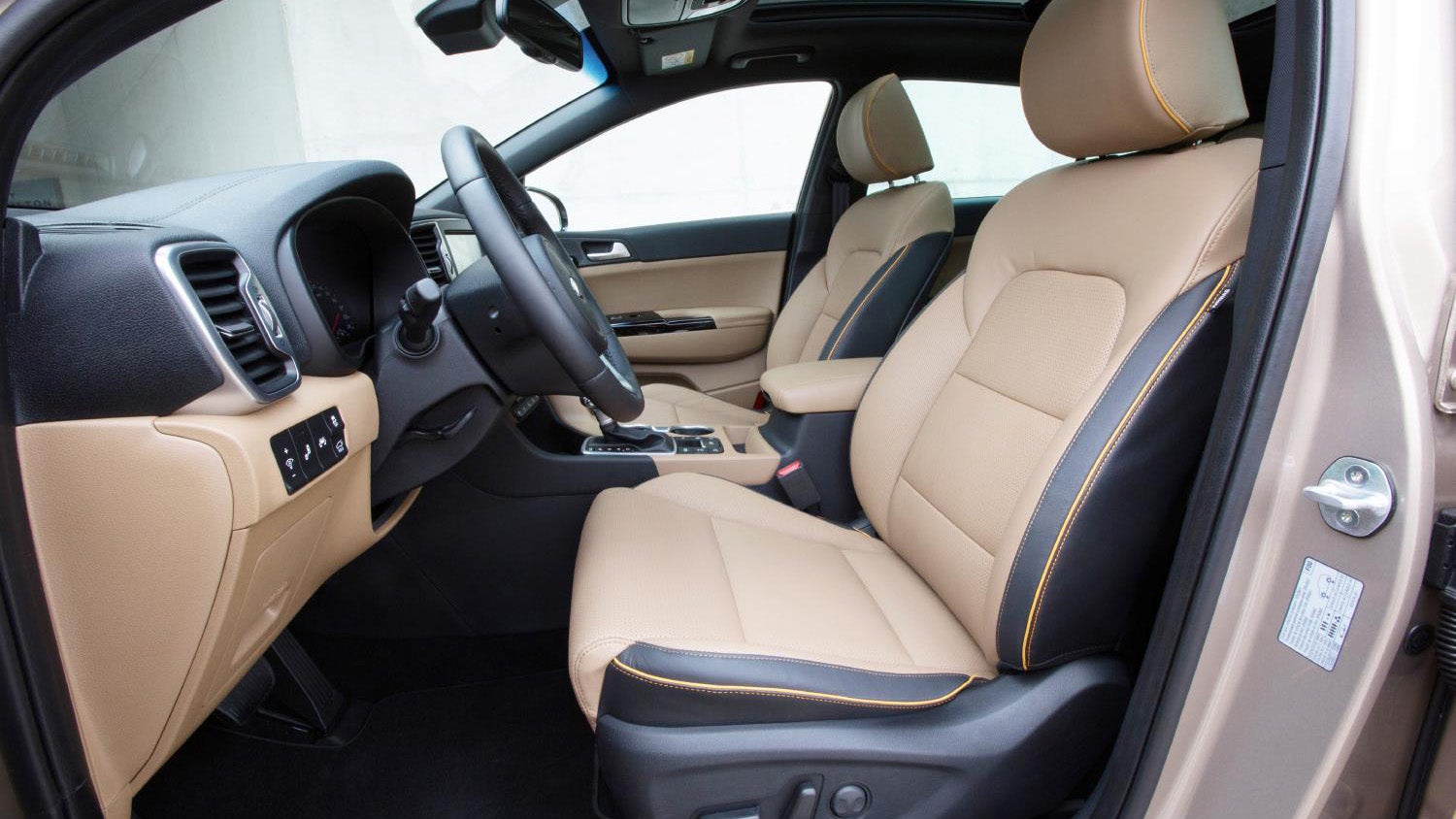 Interior view of a Kia Sportage showing seats and dashboard.