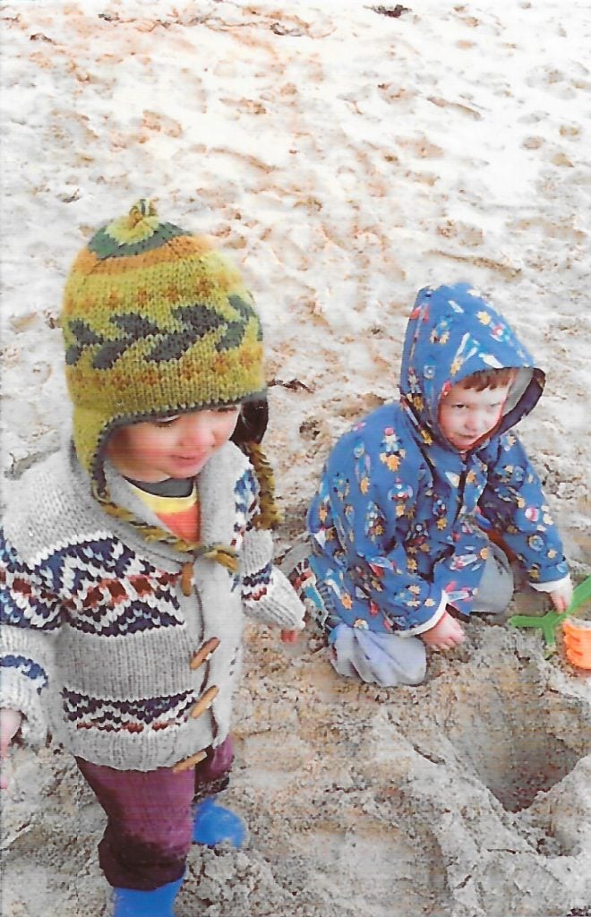 Two children playing in the sand.Photo print of a mountain landscape by HP Sprocket.