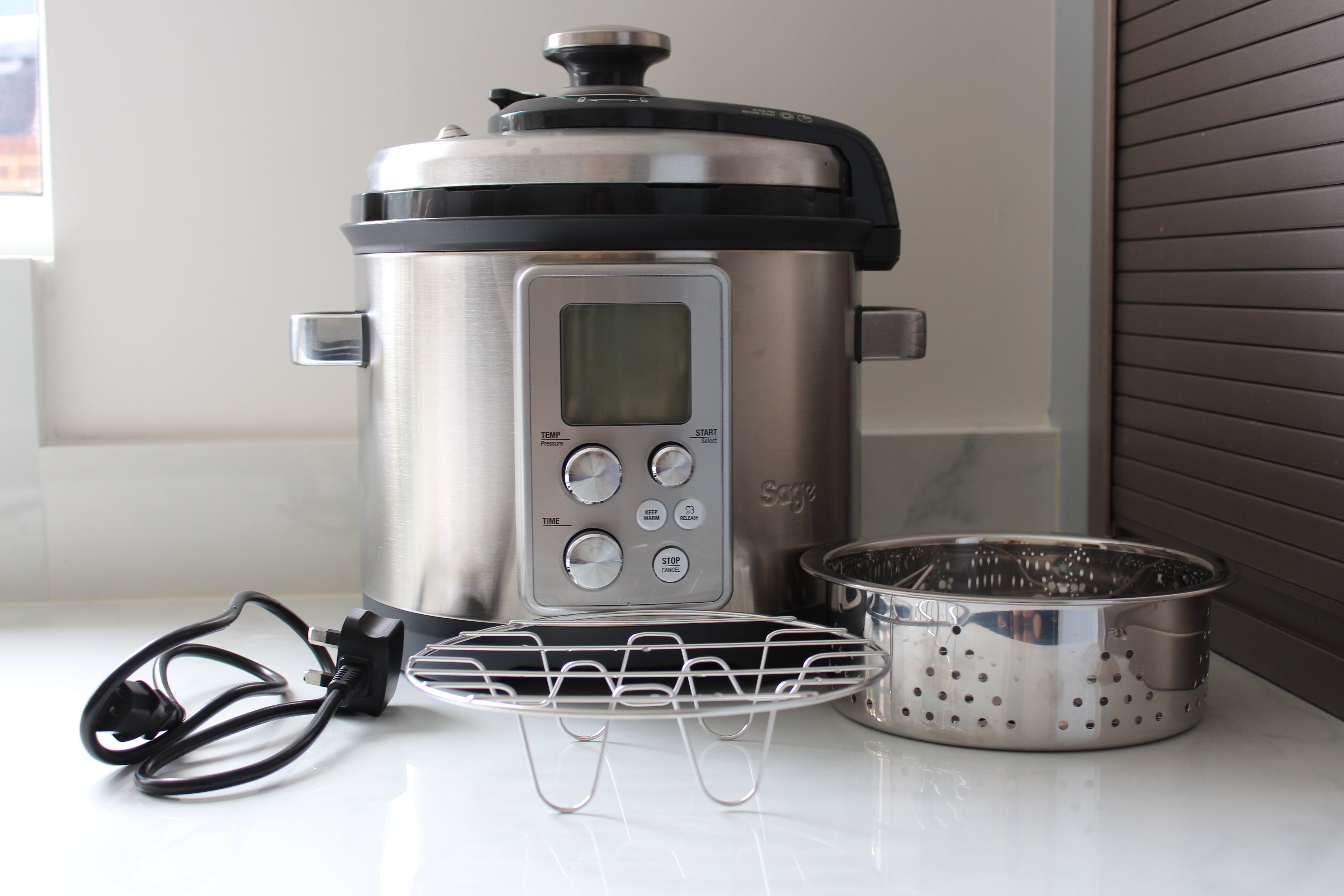 Sage Fast Slow Pro pressure cooker with accessories.