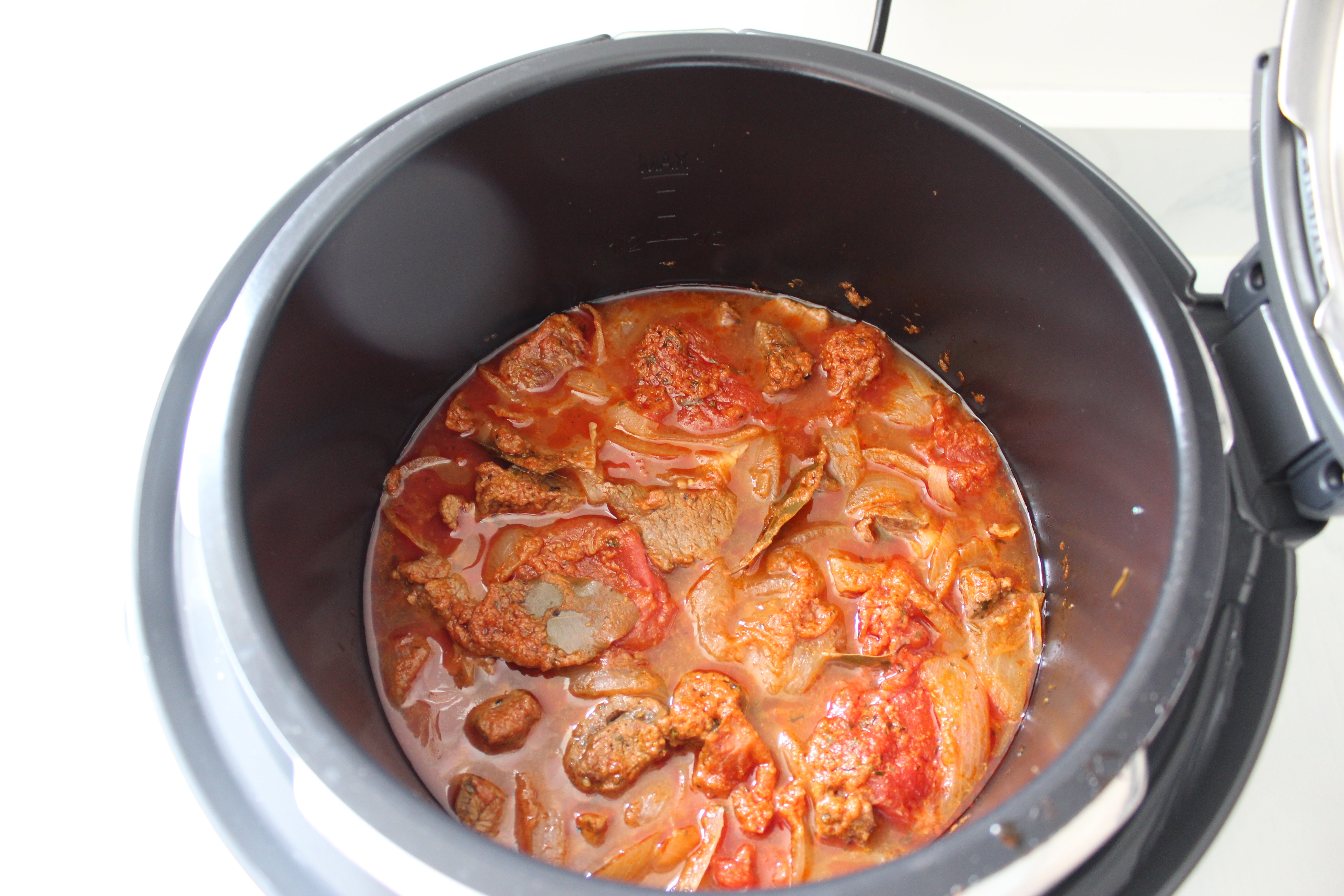Stew cooking inside Sage Fast Slow Pro pressure cooker.