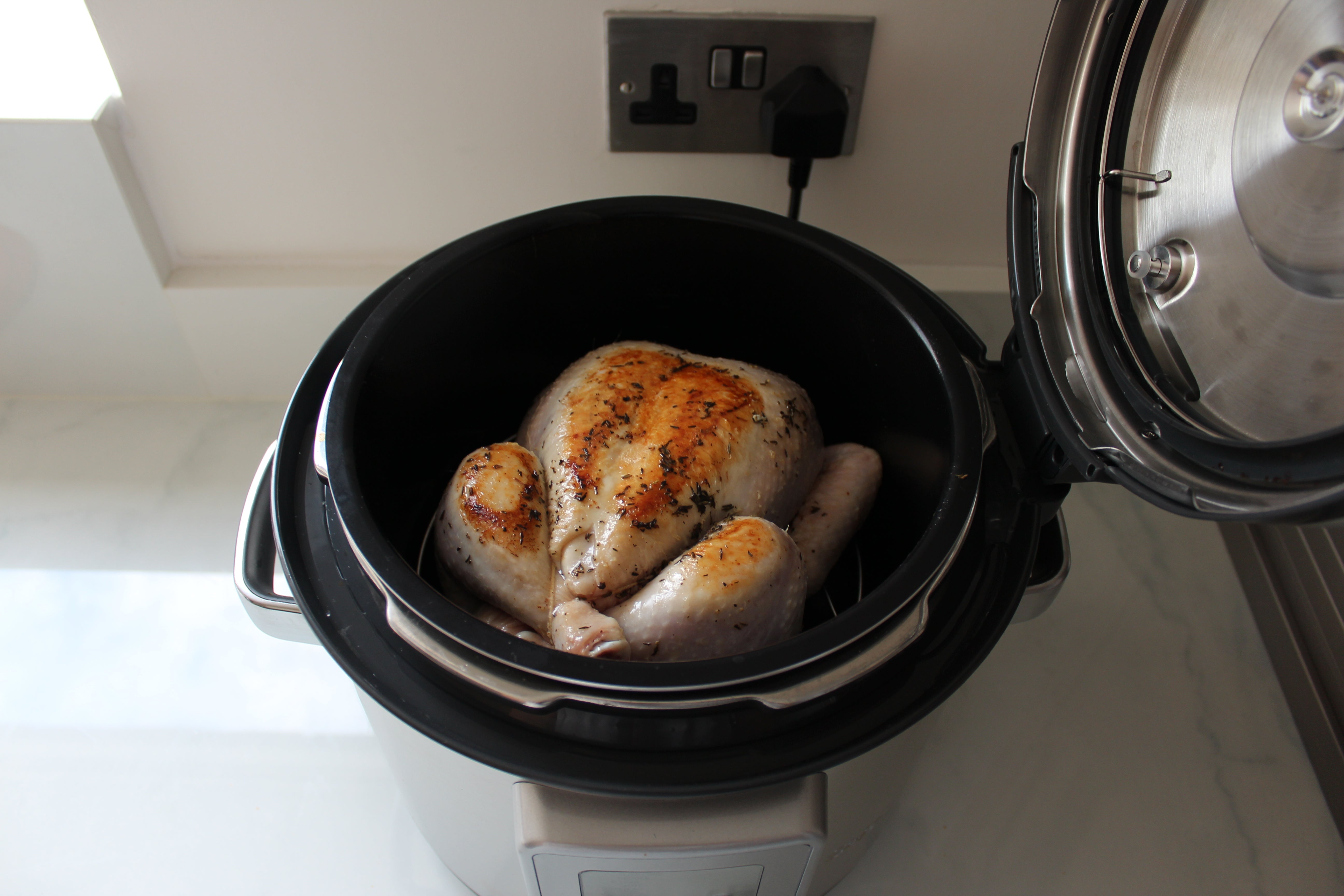 Sage Fast Slow Pro pressure cooker with roasted chicken.