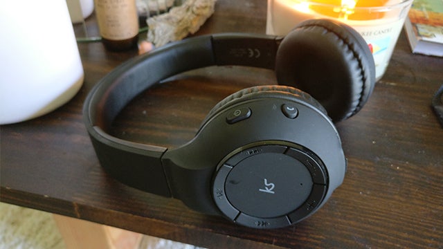 KitSound Arena wireless headphones on a wooden table
