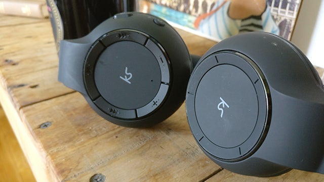 KitSound Arena wireless headphones on wooden surface.