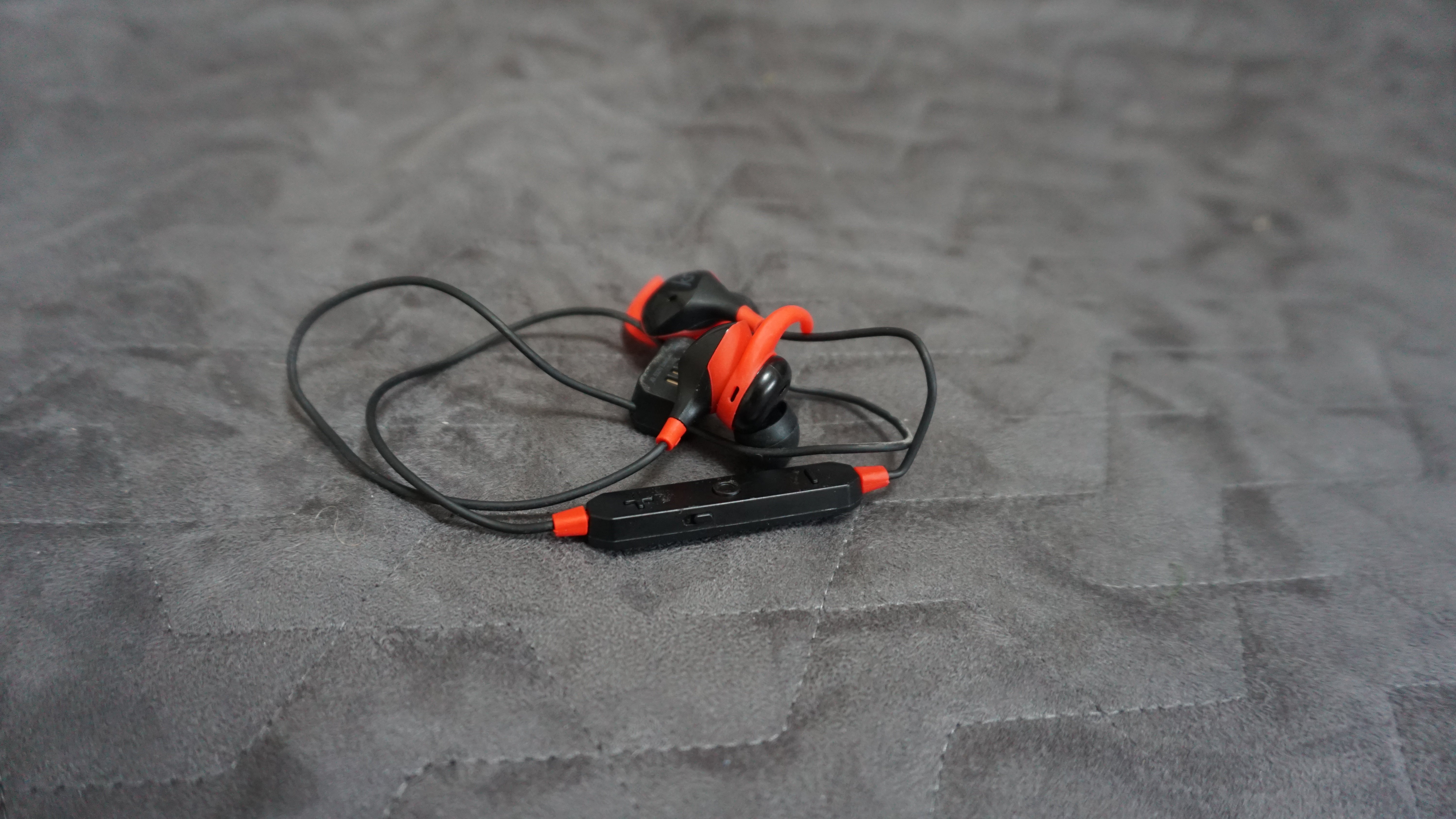 KitSound Immerse Active wireless earphones on gray background.