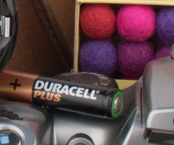 Close-up of Duracell battery with colorful background.