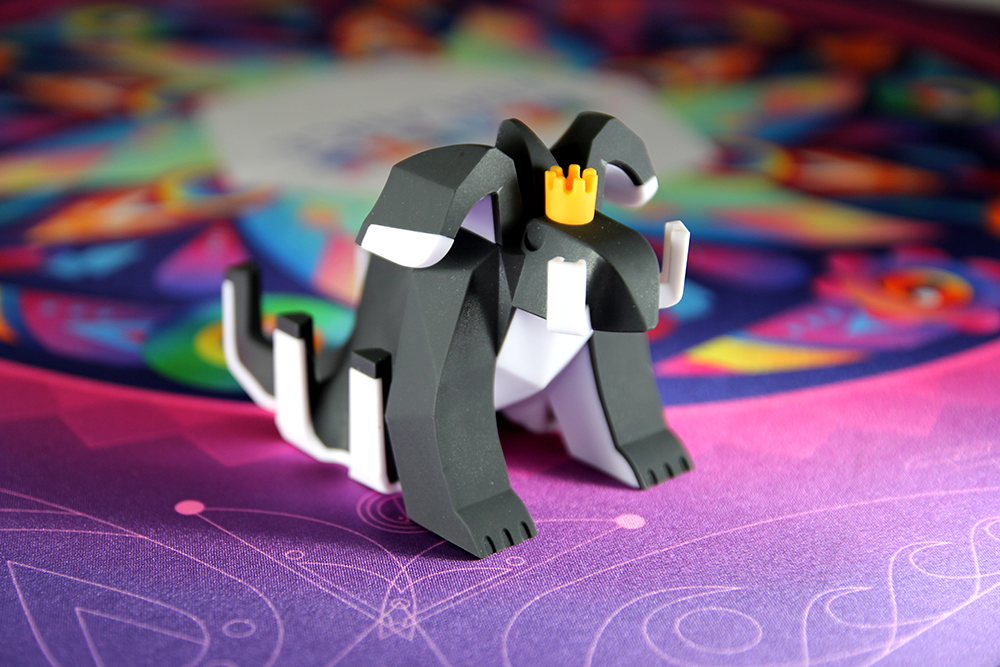 Beasts of Balance game figurine on colorful play mat.