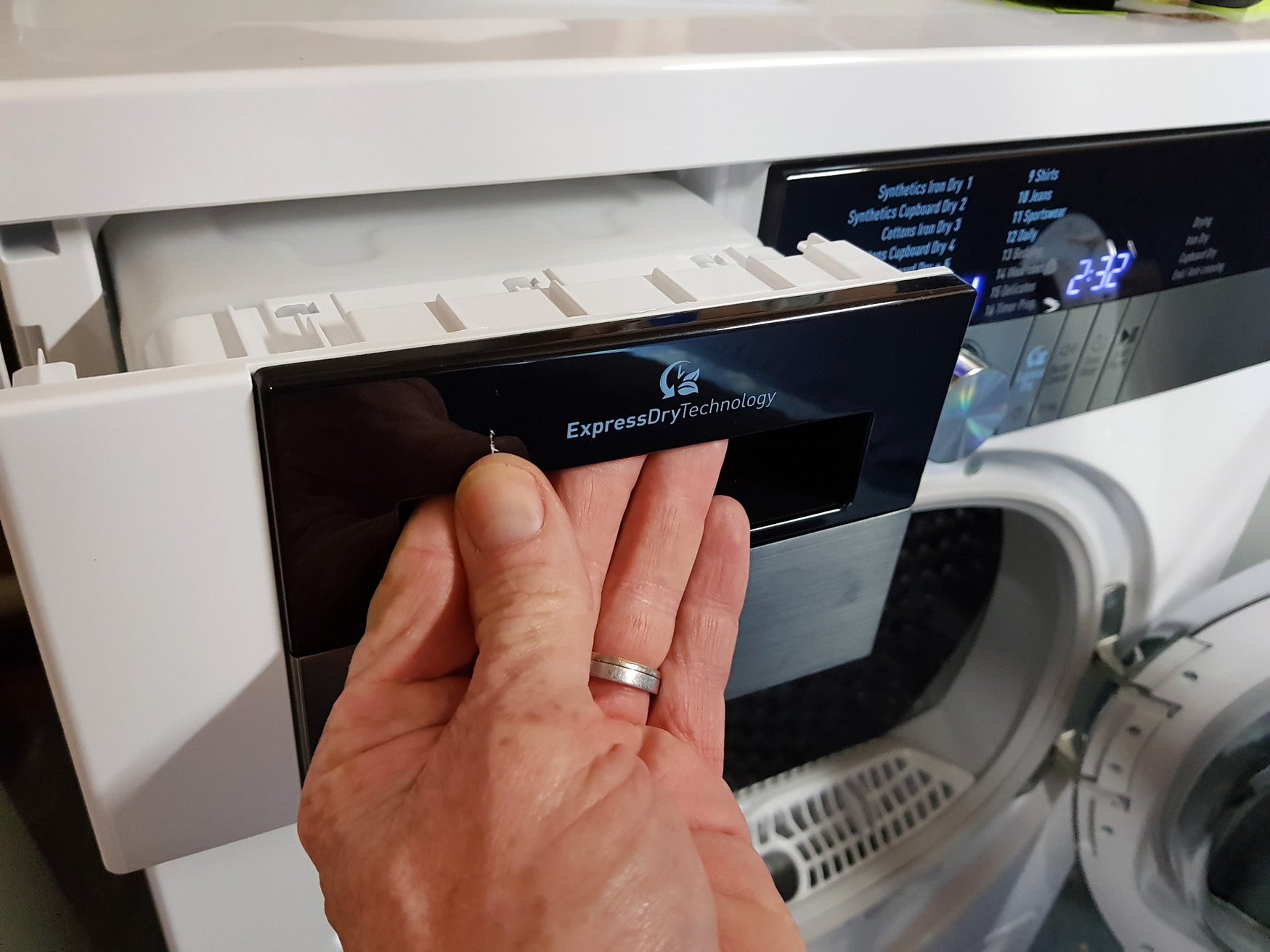 Hand opening detergent drawer of Grundig GTN38267GCW dryer.