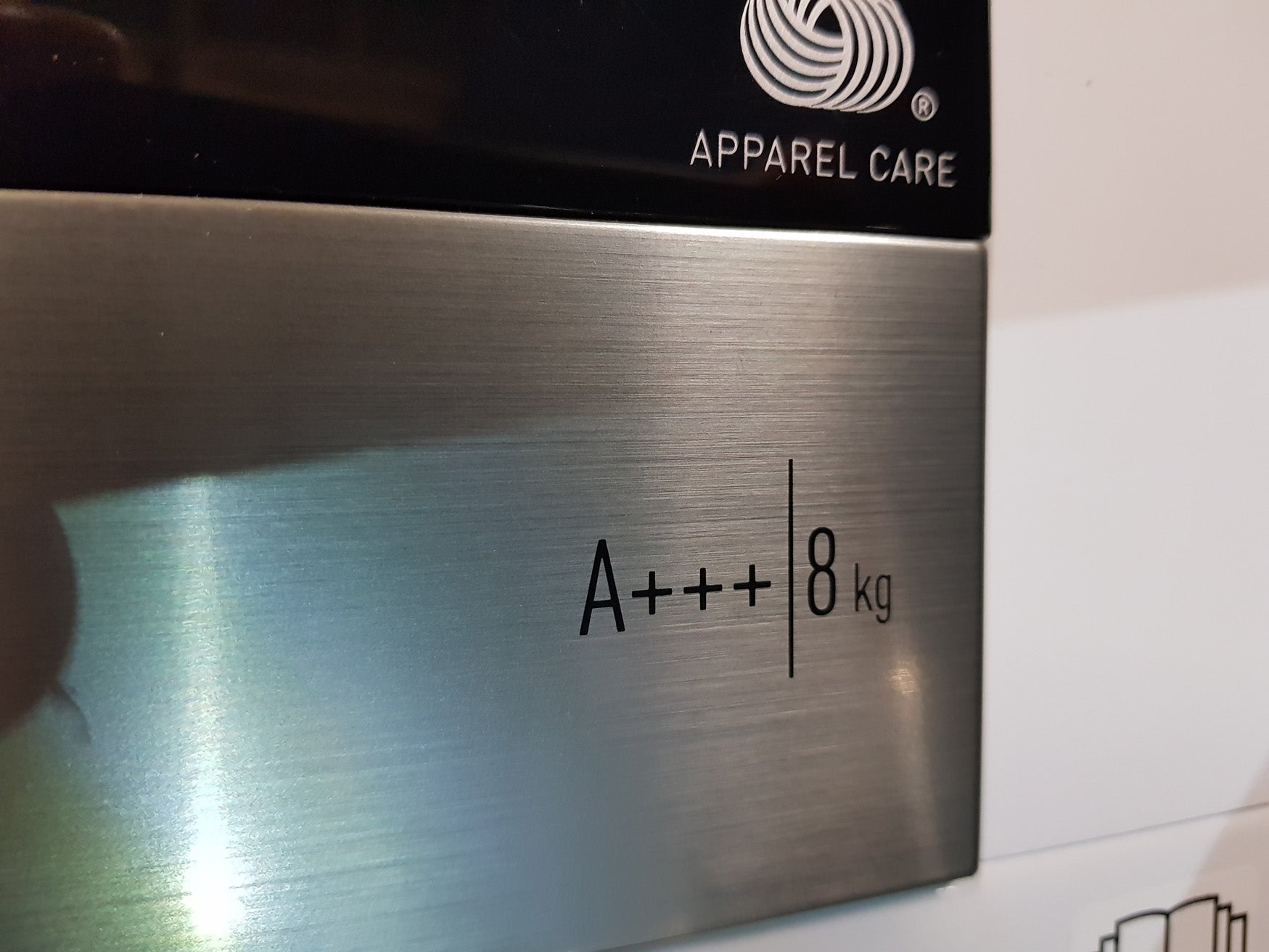 Close-up of Grundig dryer efficiency rating label A+++ and 8 kg capacity.