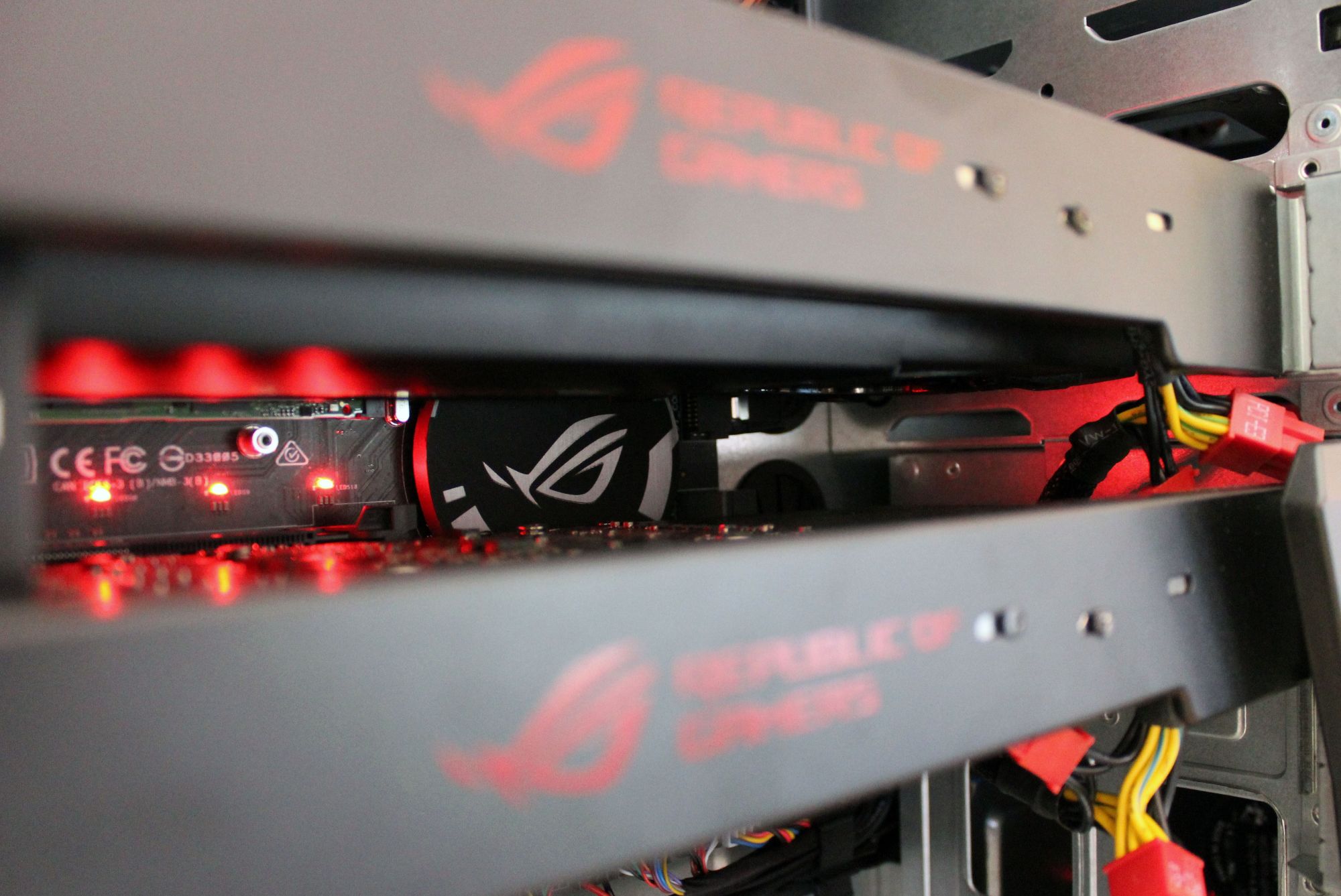Close-up inside Asus ROG GT51CH gaming PC with illuminated components.