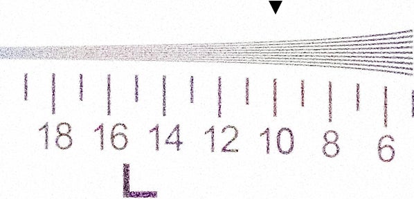 Close-up of a measuring tape showing numbers and scale marks.