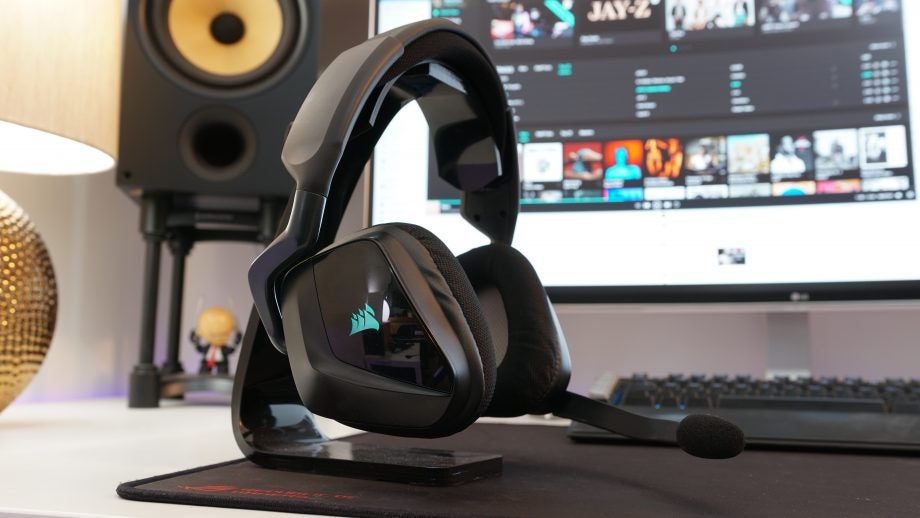 Corsair Void Pro RGB headset on a desk with computer background.