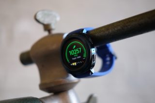 Samsung Gear Sport smartwatch showing step count on display.