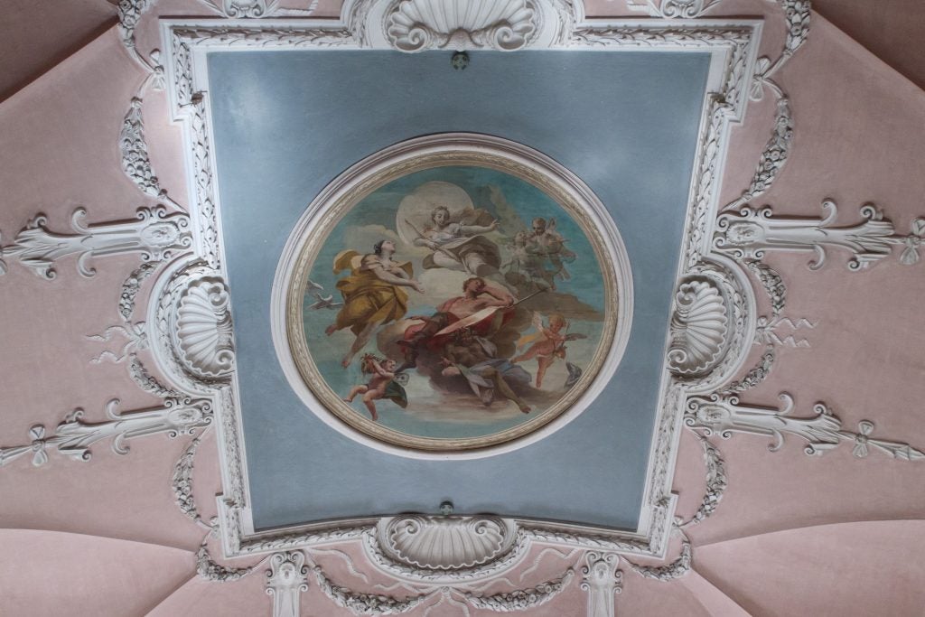 Ornate ceiling fresco with intricate frame and detailing.