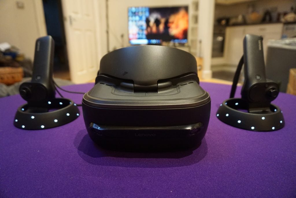 Lenovo Explorer VR headset and motion controllers on table.