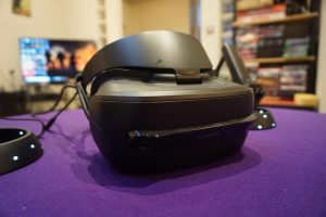 Lenovo Explorer VR headset on purple surface with blurred background.