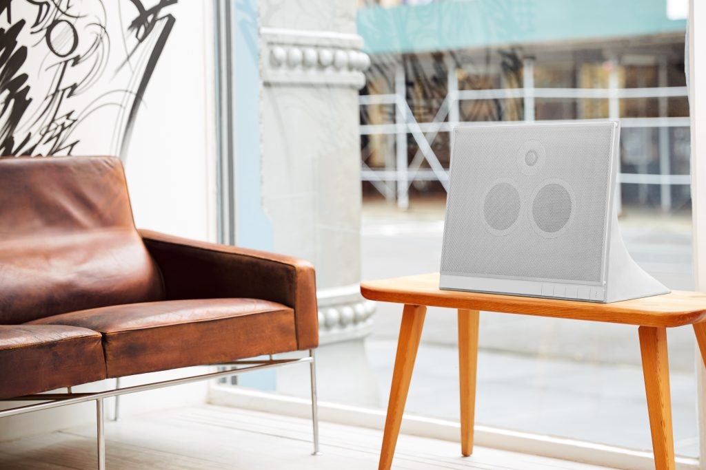 Master & Dynamic MA770 speaker on a wooden table.