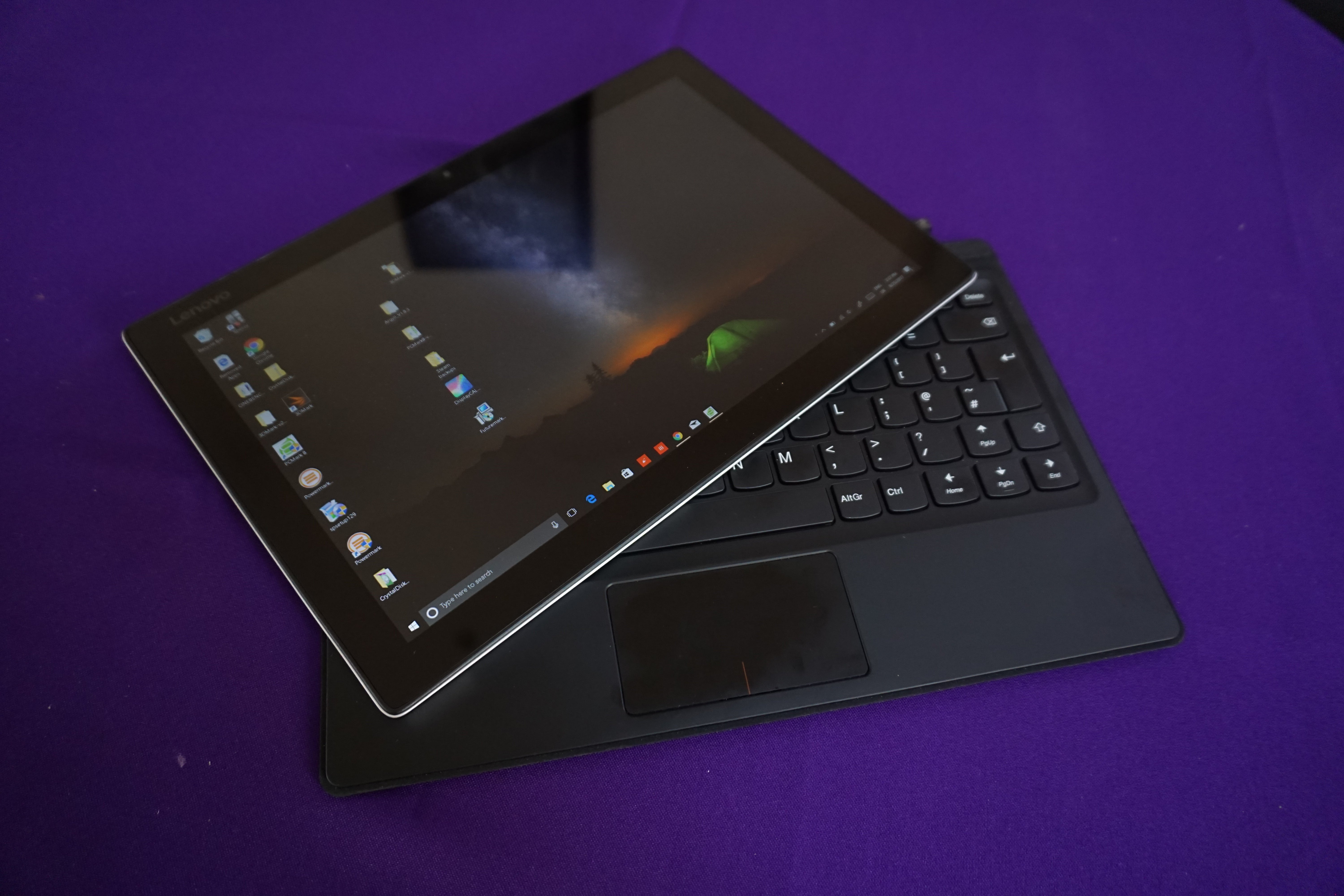 Lenovo Miix 510 hybrid tablet with keyboard on purple surface.Lenovo Miix 510 hybrid laptop on purple surface.