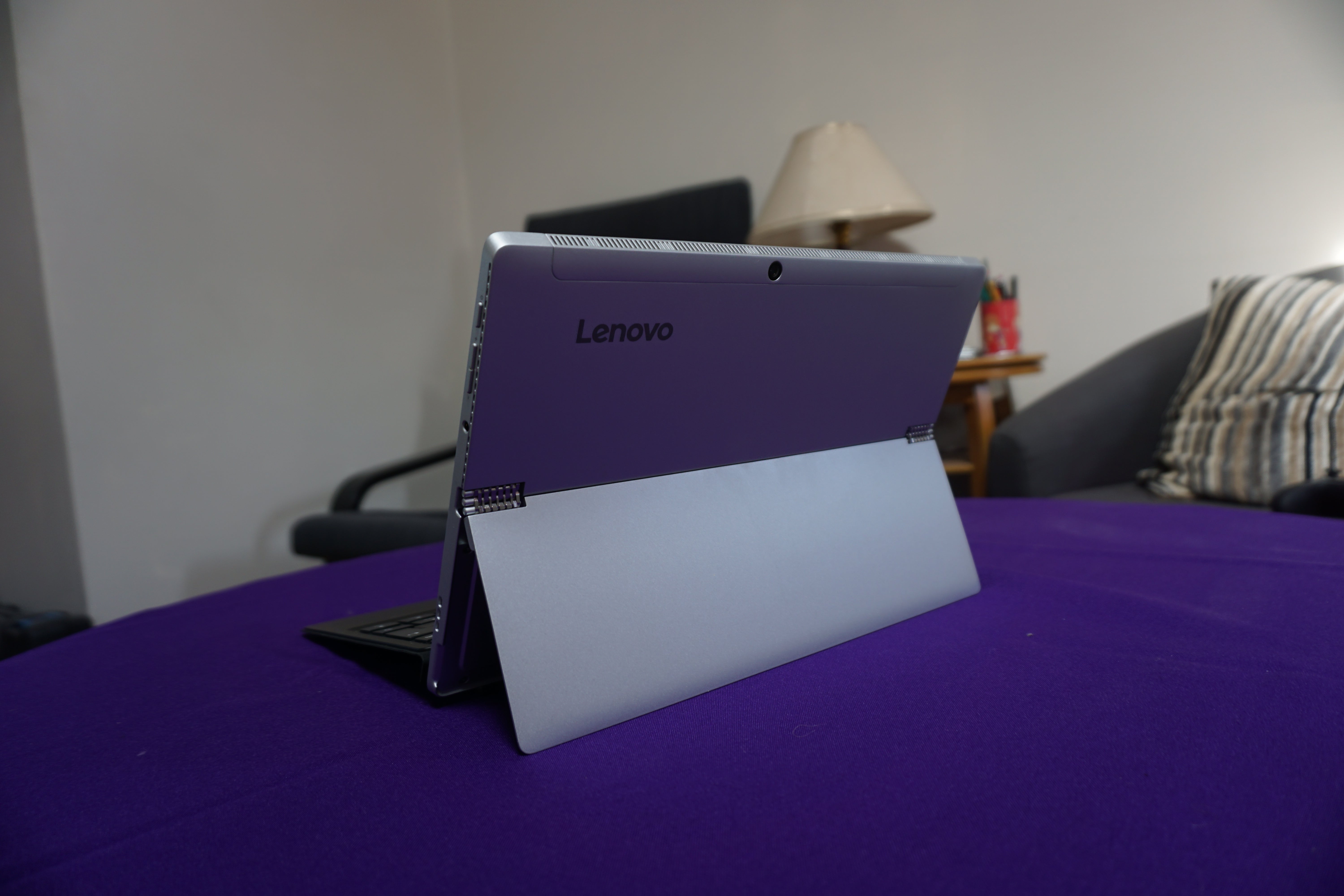 Lenovo Miix 510 convertible tablet with keyboard on purple surface.