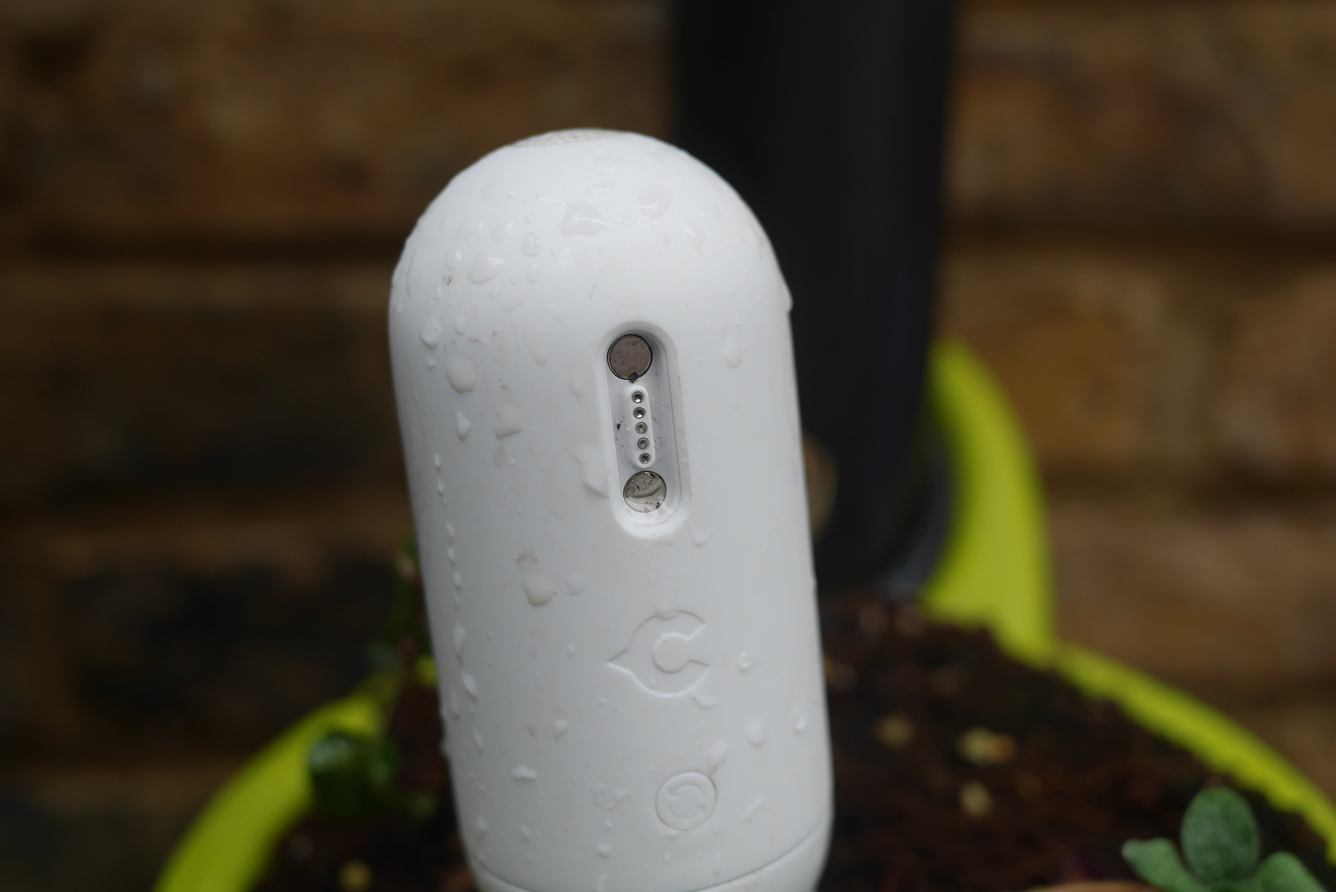 Canary Flex security camera with water droplets on it.
