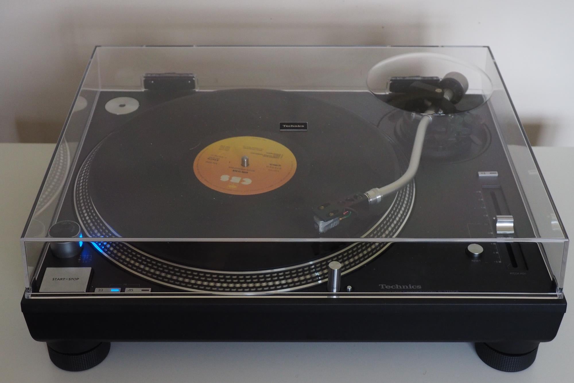 Technics SL-1200GR turntable with vinyl record playing.