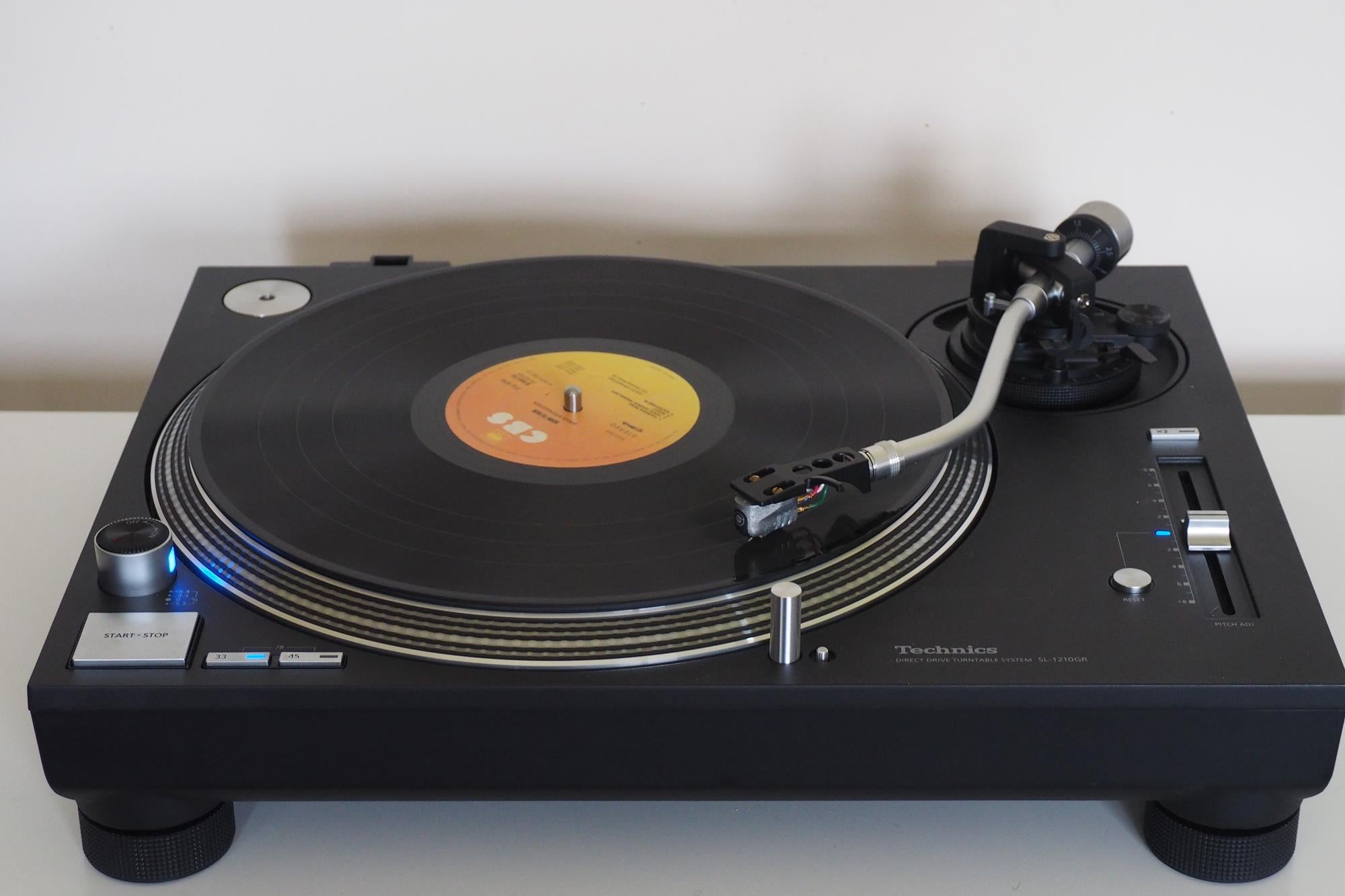 Technics SL-1200GR turntable with vinyl record playing.