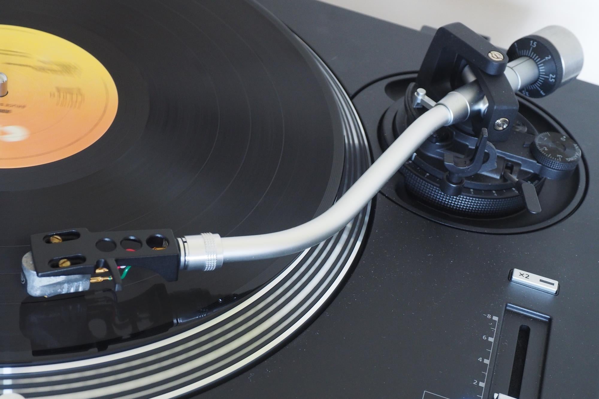 Technics SL-1200GR turntable with a playing vinyl record.