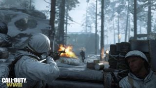 Call of Duty WWII in-game action scene with soldiers and flame.