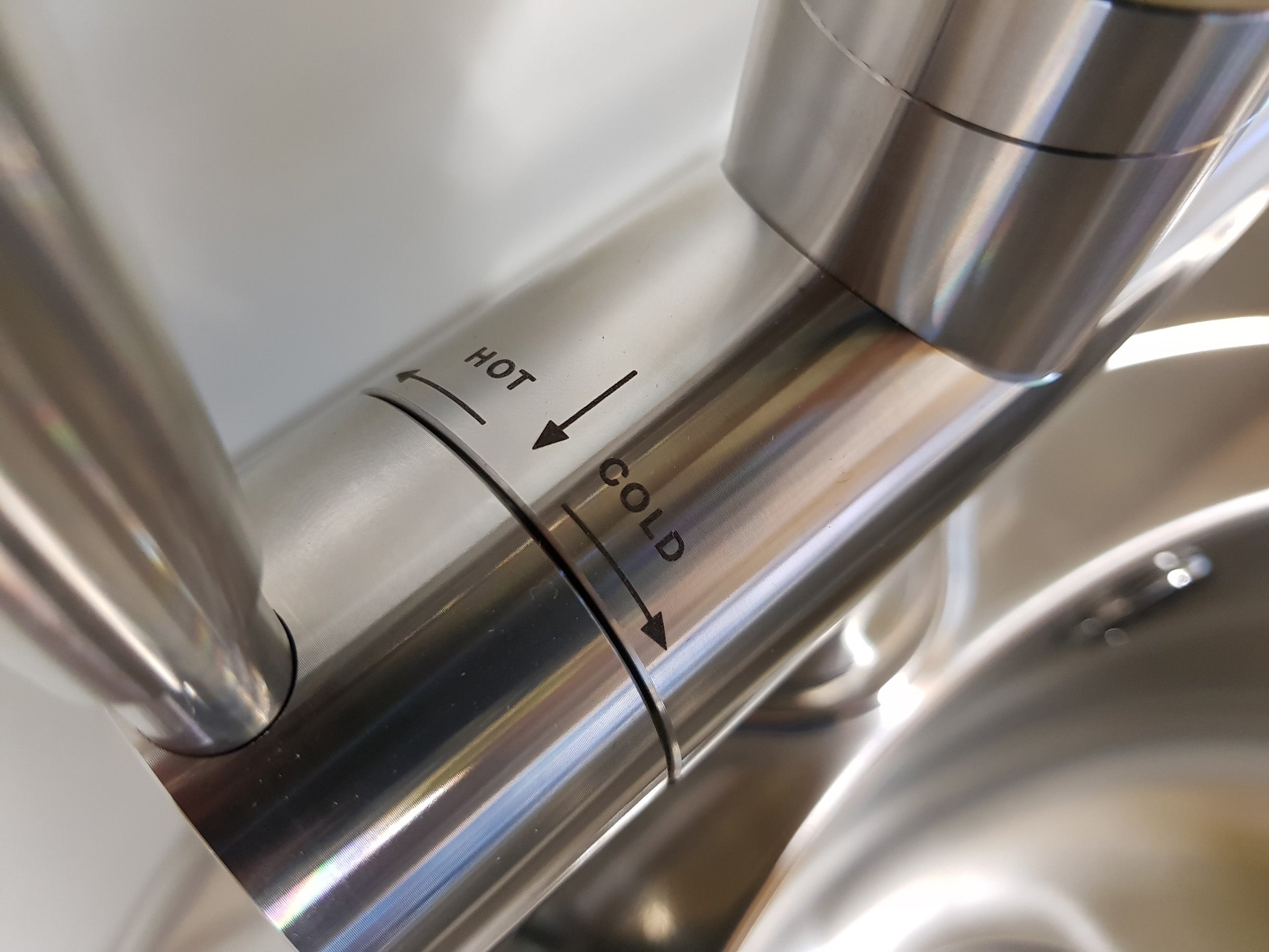 Close-up of Franke boiling tap with hot and cold indicators.