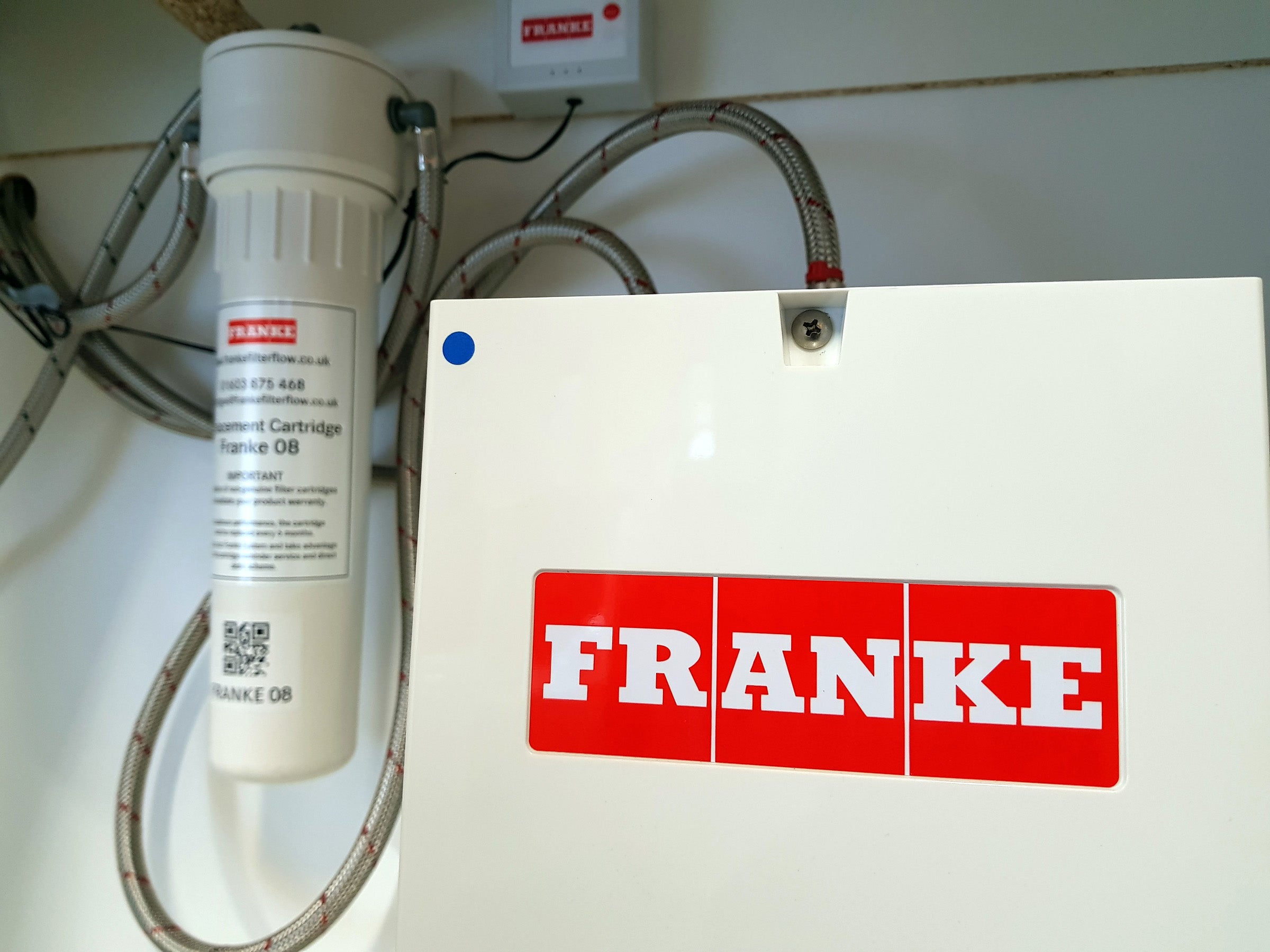 Franke filter system with logo on boiler under sink.