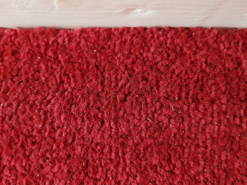 Close-up texture of a clean red carpet.