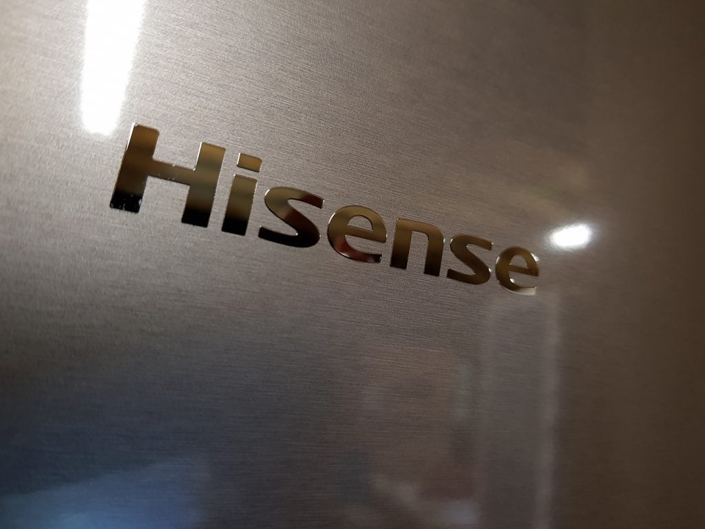Close-up of Hisense logo on a stainless steel fridge.
