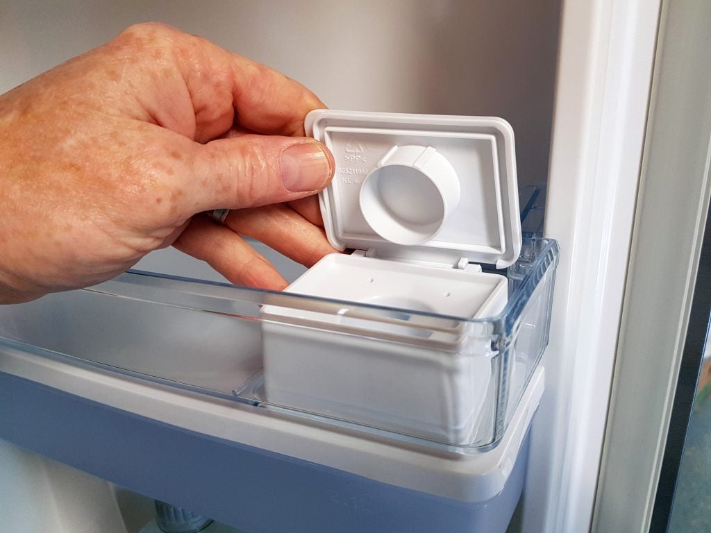 Hand opening ice maker compartment in a Hisense fridge