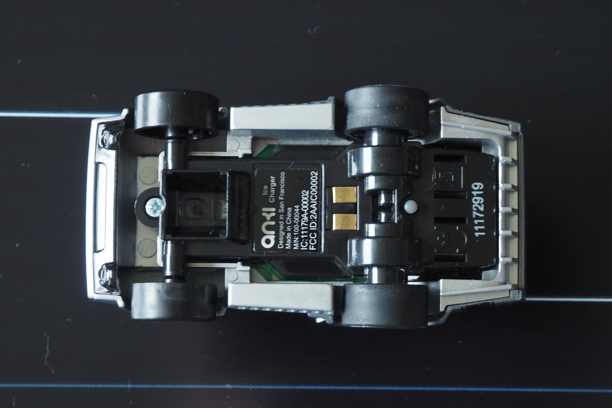 Anki Overdrive car underside showing wheels and optical sensor.
